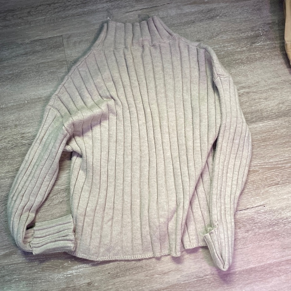 This is a tan sweater.